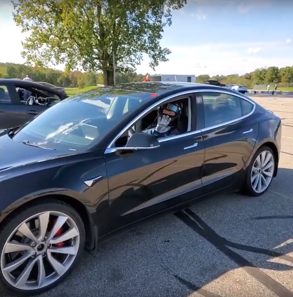 Picture of Ryan at the race track in his black Tesla Model 3 Performance.