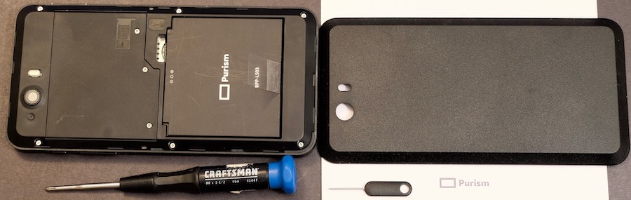 Photo of the LIbrem 5 phone with the back cover removed, which shows the user-serviceable battery, cellular modem, and WiFi/Bluetooth. Also in the photo is the excellent SIM extraction tool and a small Phillips screwdriver.