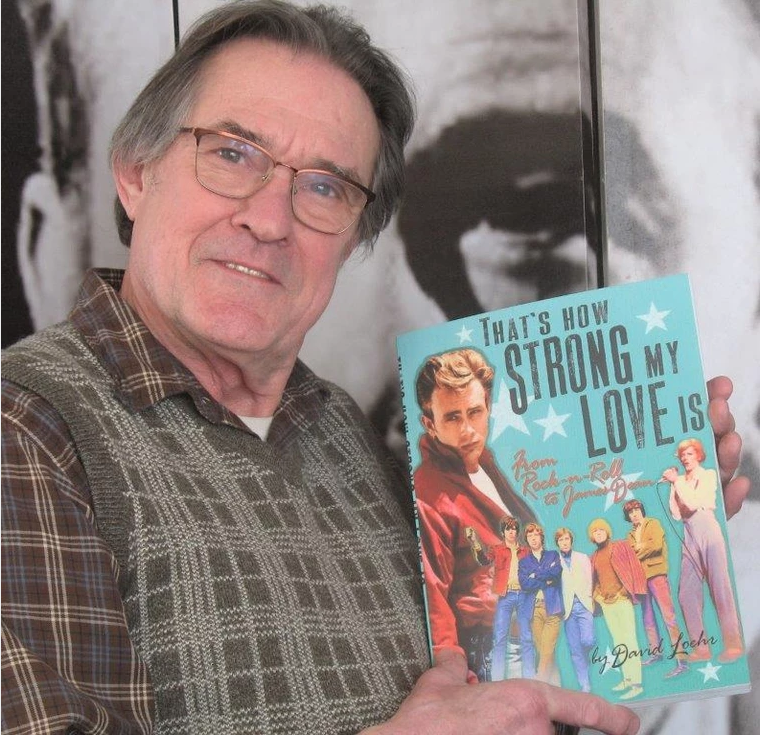 Photo of author holding his new book.