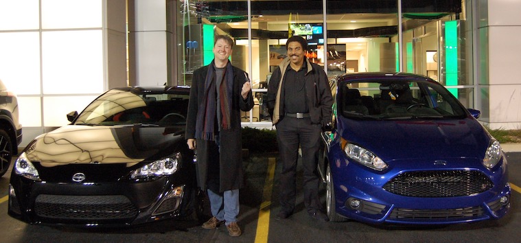 Photo of Tim in front of his new car.